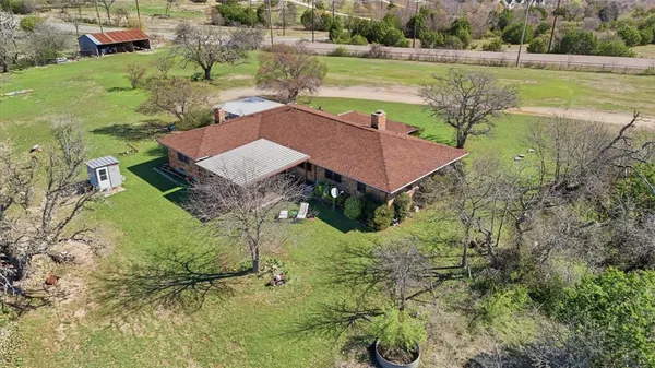 an aerial view of a house with a yard