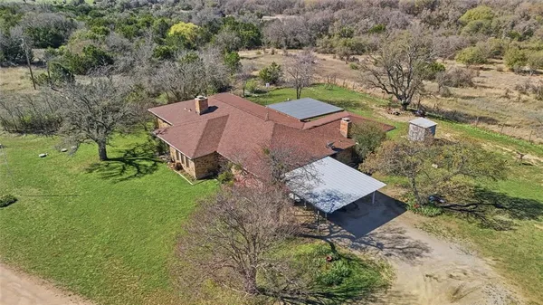 a view of a house with a yard and a lake view