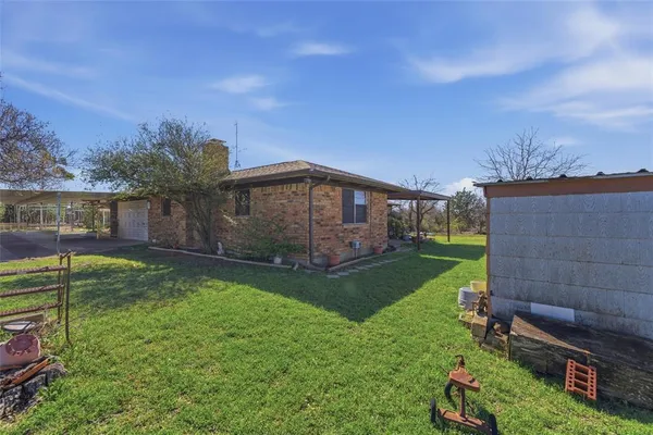 a view of a house with backyard and porch