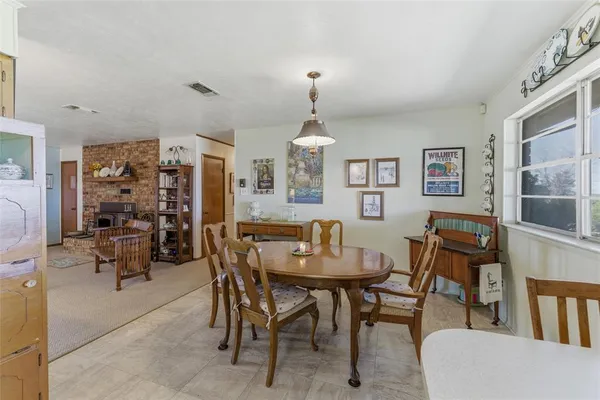 a view of a dining room with furniture and a chandelier