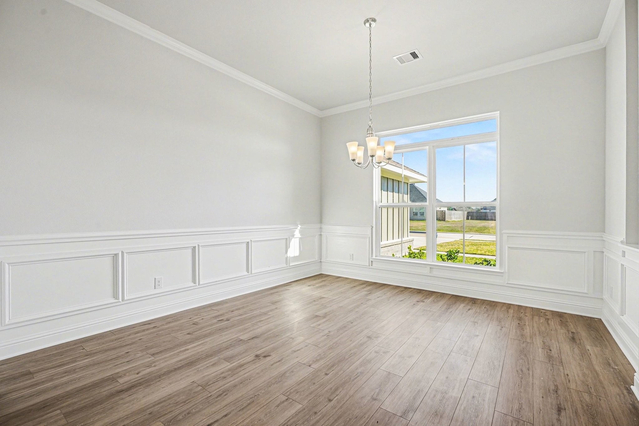 5 Keystone Court Angleton, TX 77515 - Photo 16 of 33 a view of an empty room with wooden floor and a window