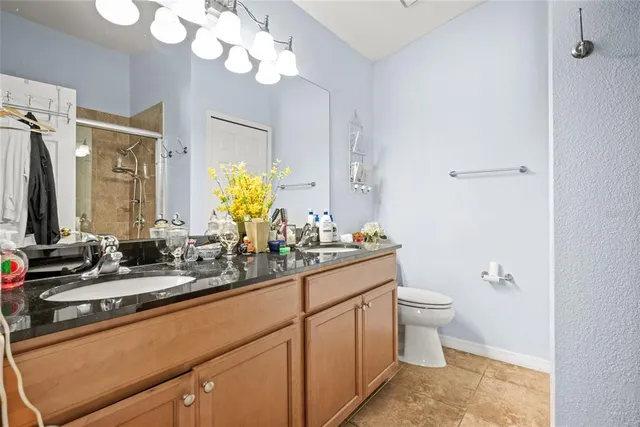 a bathroom with a double vanity sink mirror and toilet