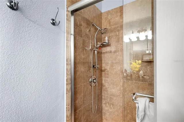 a bathroom with a glass shower door