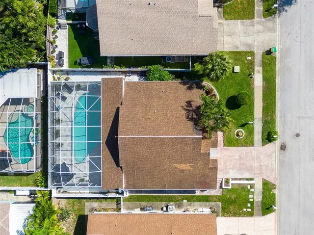 an aerial view of a house with a yard