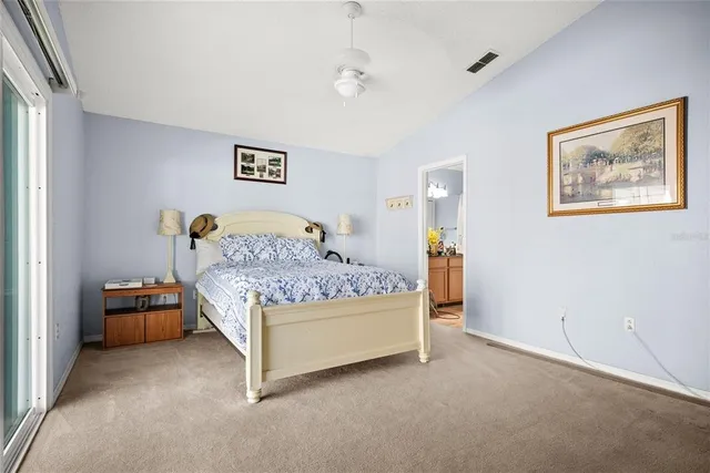 a bedroom with a bed lamp and a window