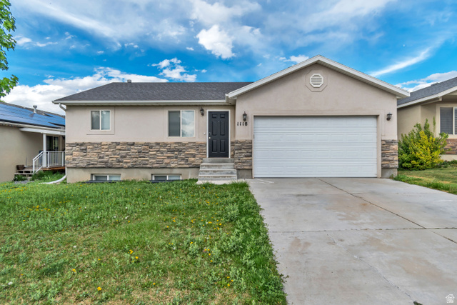 1118 North Ridge Court Spanish Fork, UT 84660 - Photo 1 of 32 Ranch-style home with stone siding, stucco siding, an attached garage, and concrete driveway