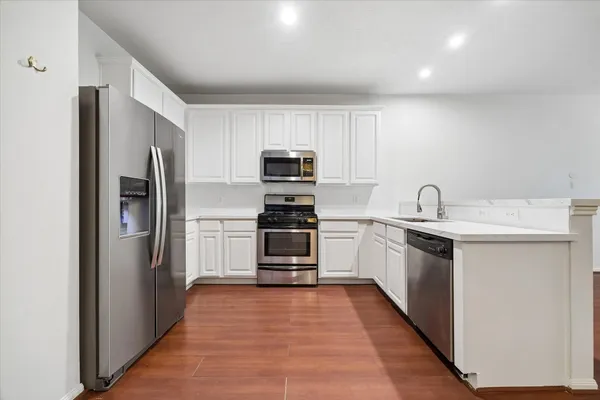 a kitchen with a refrigerator sink and oven