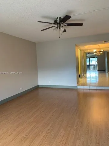 a view of a room with wooden floor and white walls