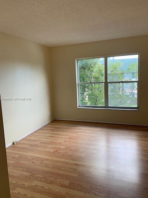 3710 Inverrary Drive, Unit 3K Lauderhill, FL 33319 - Photo 5 of 8 wooden floor in an empty room with a window