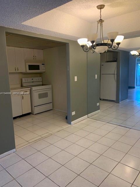 3710 Inverrary Drive, Unit 3K Lauderhill, FL 33319 - Photo 7 of 8 a view of a kitchen with microwave and cabinets