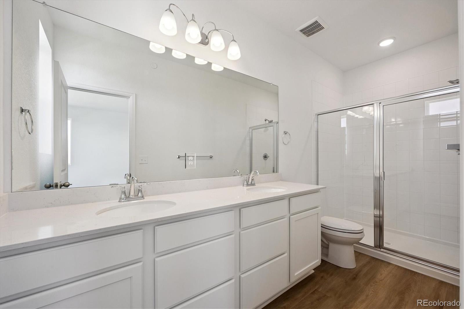 2870 Taryn Street Erie, CO 80026 - Photo 18 of 21 a bathroom with a double vanity sink mirror and toilet