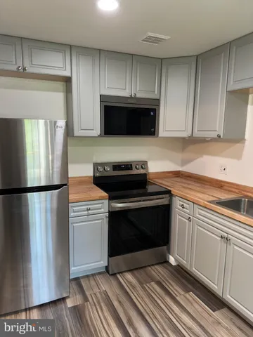 a kitchen with a stove and a refrigerator
