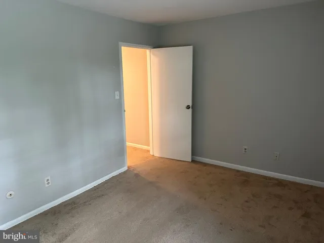a view of an empty room and a window