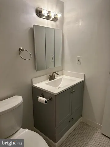 a bathroom with a sink toilet and mirror
