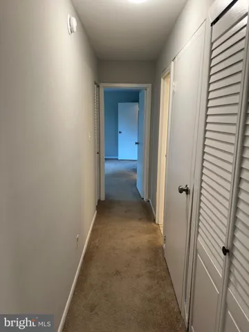 a view of a hallway with a door