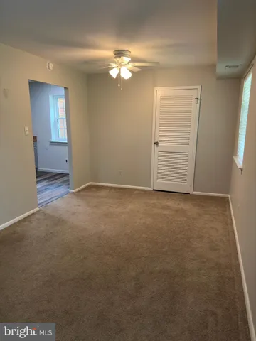 an empty room with windows and entrance