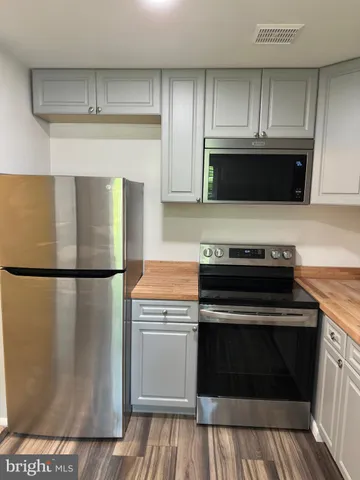 a kitchen with a stove and a refrigerator