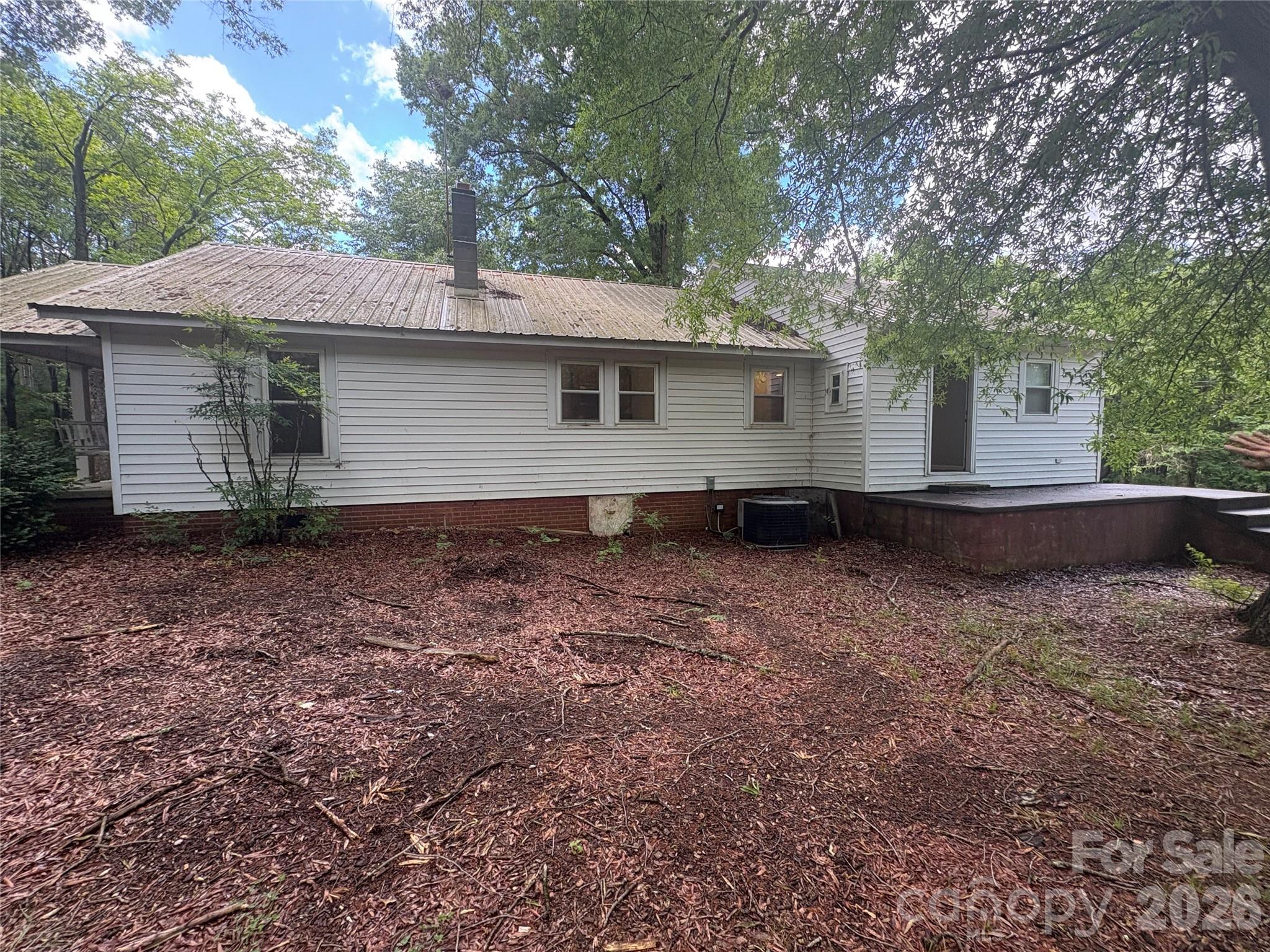 3880 Love Road Claremont, NC 28610 - Photo 2 of 14 a backyard of a house with large trees