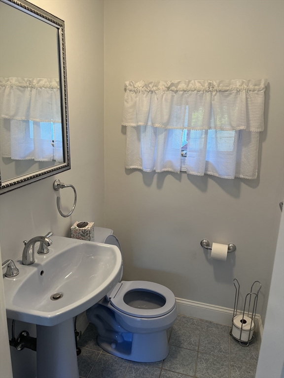 21 Grove Street Saugus, MA 01906 - Photo 4 of 10 a bathroom with a sink and a mirror