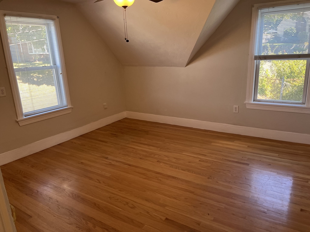 21 Grove Street Saugus, MA 01906 - Photo 7 of 10 an empty room with wooden floor and windows