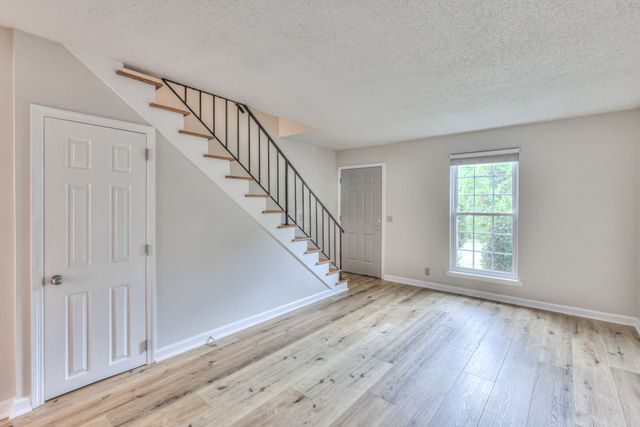 a view of an entryway with wooden floor