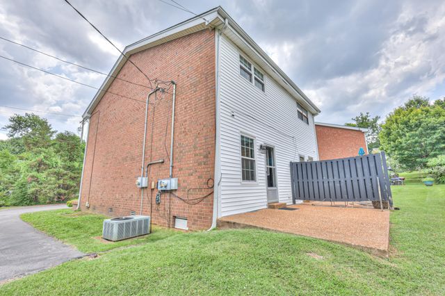 a backyard of a house with table and chairs