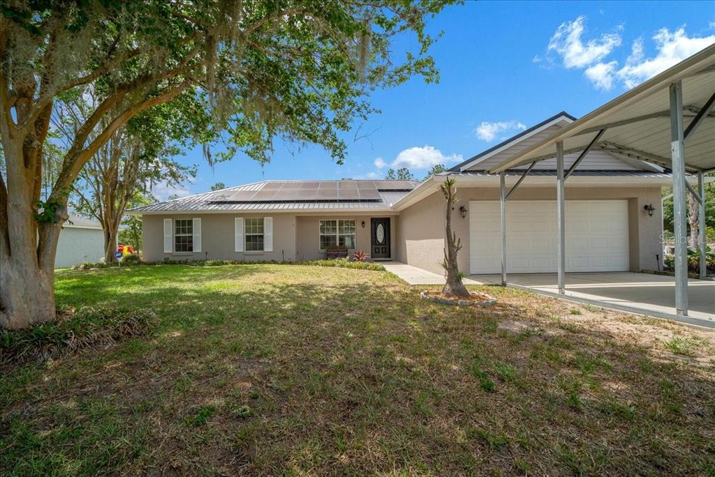 234 Locust Lane Ocala, FL 34472 - Photo 33 of 71 a view of a yard in front of a house with plants and large tree