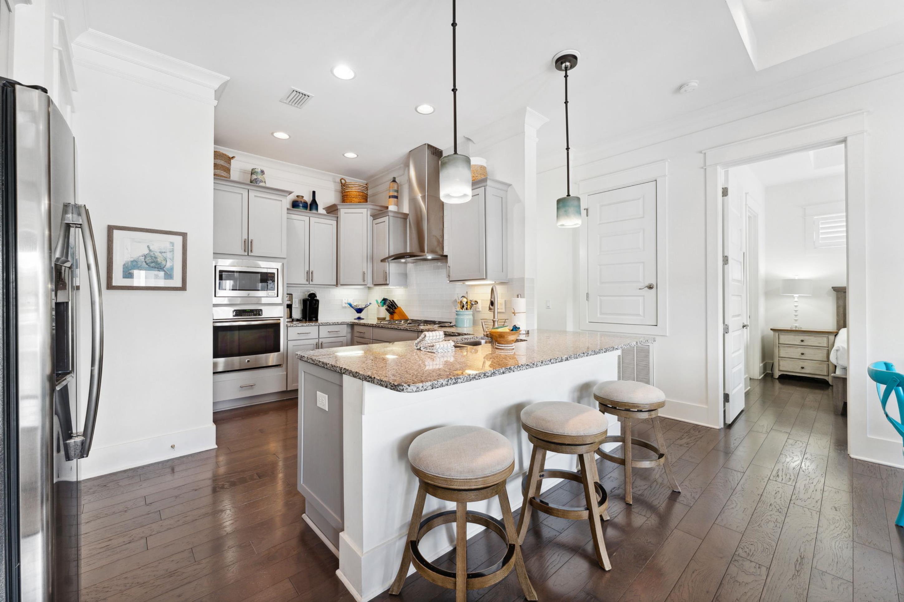 57 Milestone Dr Inlet Beach, Unit C Inlet Beach, FL 32461 - Photo 12 of 35 a kitchen with kitchen island a dining table chairs stainless steel appliances and cabinets