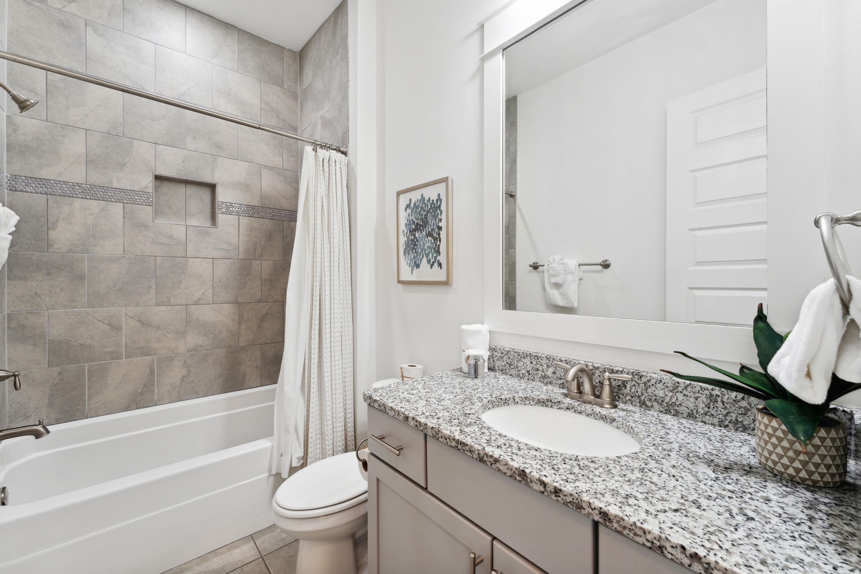 57 Milestone Dr Inlet Beach, Unit C Inlet Beach, FL 32461 - Photo 19 of 35 a bathroom with a granite countertop sink and a mirror