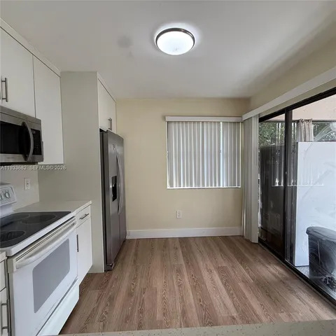 a view of a room with wooden floor
