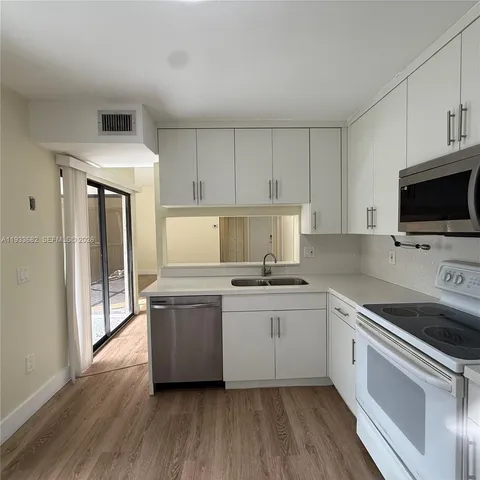 a white bath tub sitting next to a white toilet and sink