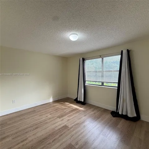 a view of a backyard with a garden and plants