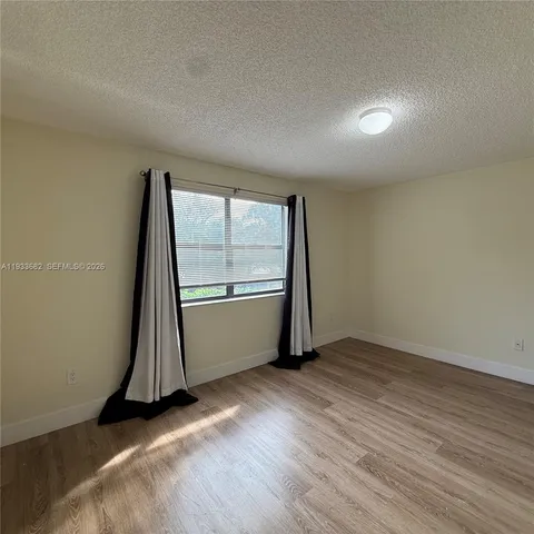 an aerial view of a house with a garden and lake view