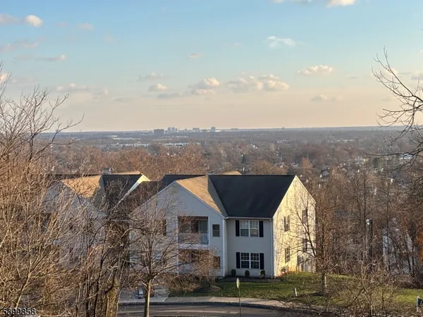 an aerial view of residential houses with a yard