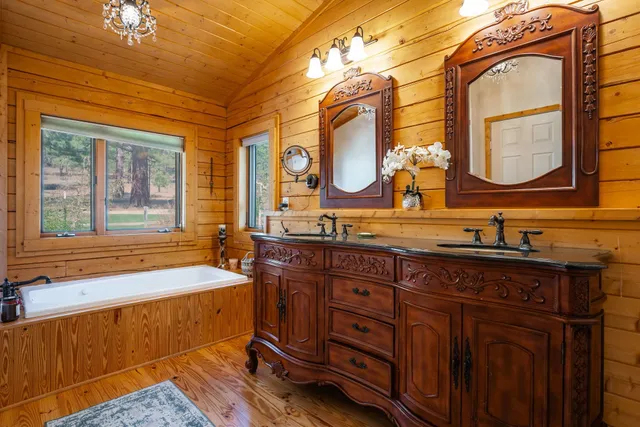 a bathroom with a bathtub and next to a window