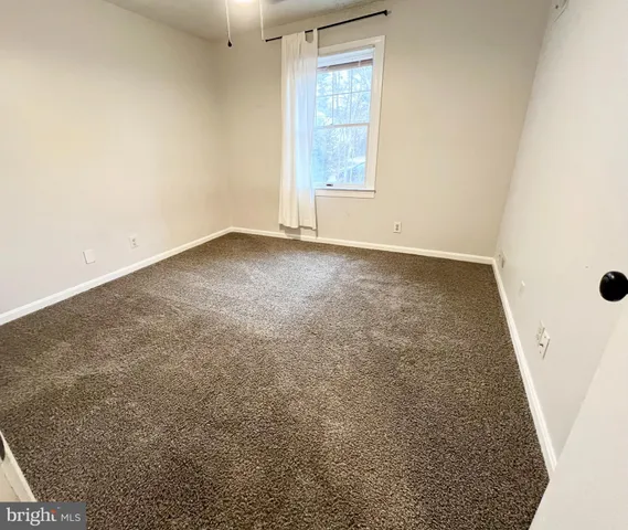 a view of an empty room and a hallway