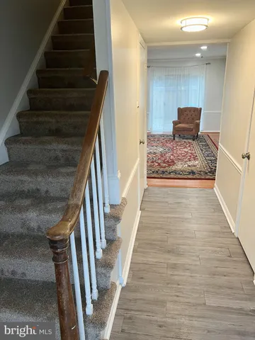 a view of entryway and hall with wooden floor