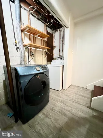 a hallway with wooden floor and a fireplace