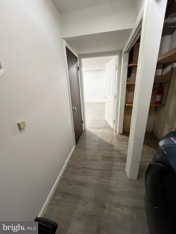 an empty room with wooden floor and white walls