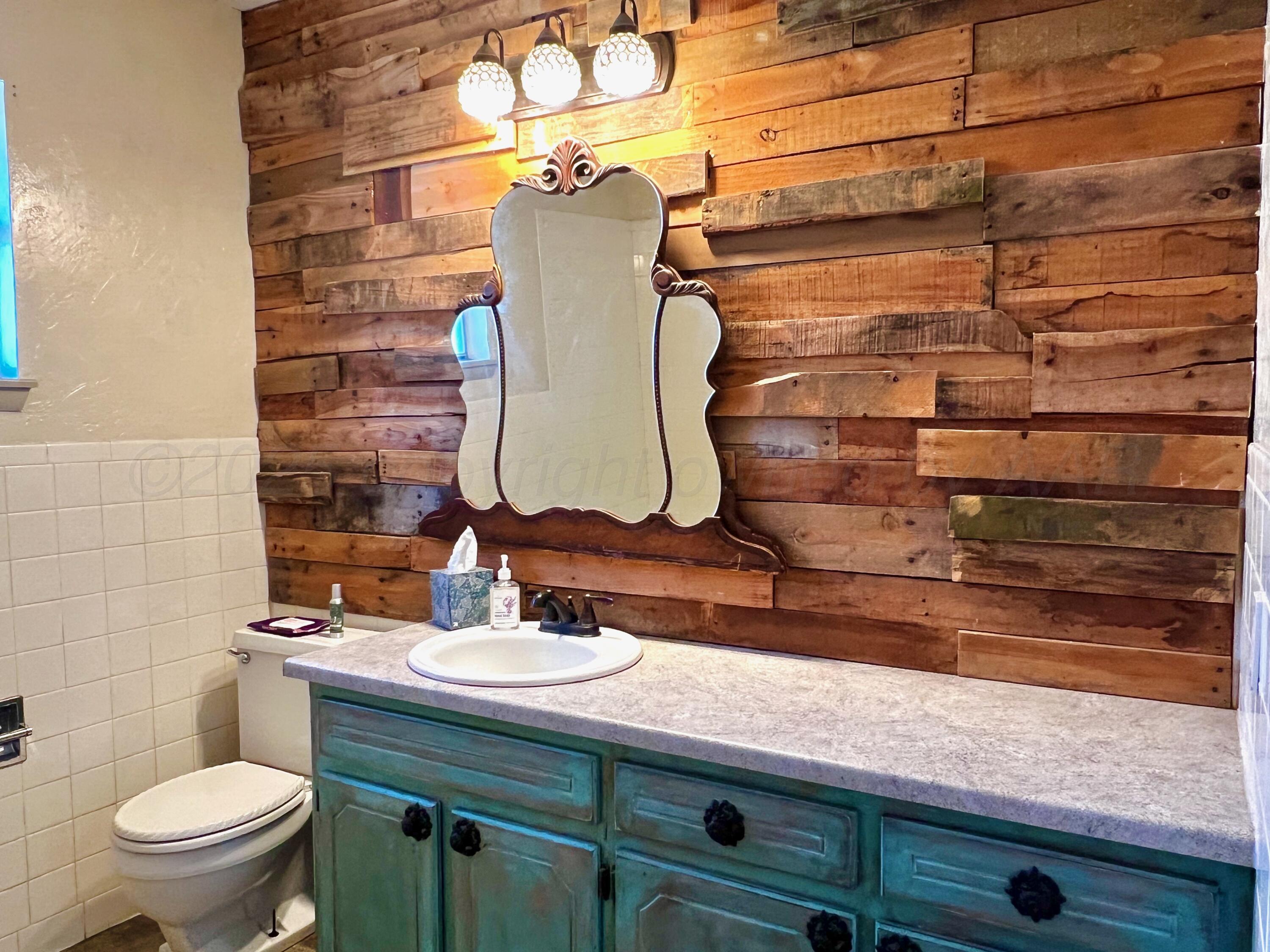 205 Houston Street Borger, TX 79007 - Photo 13 of 25 a bathroom with a sink and a toilet