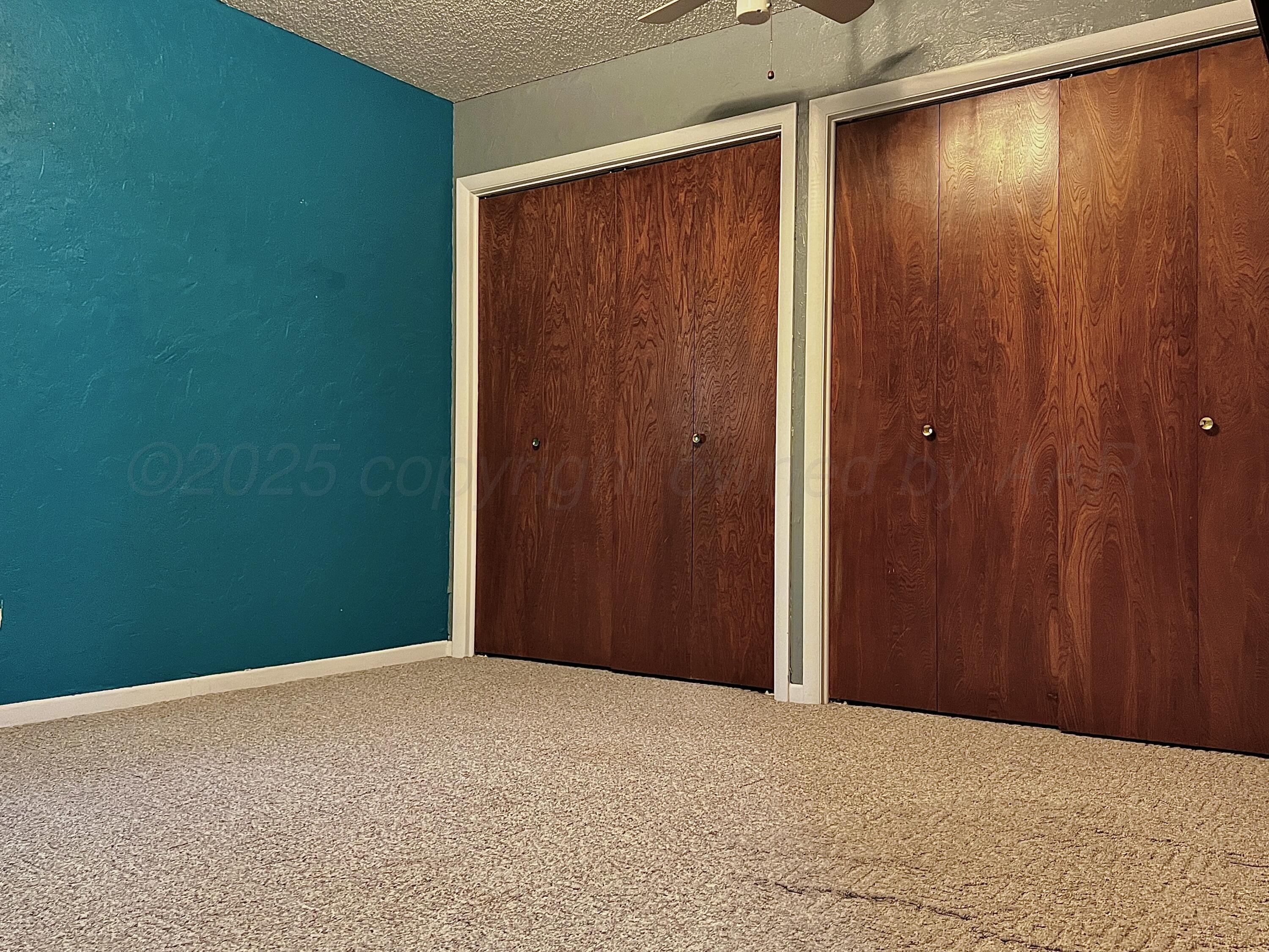 205 Houston Street Borger, TX 79007 - Photo 14 of 25 an empty room with wooden walls