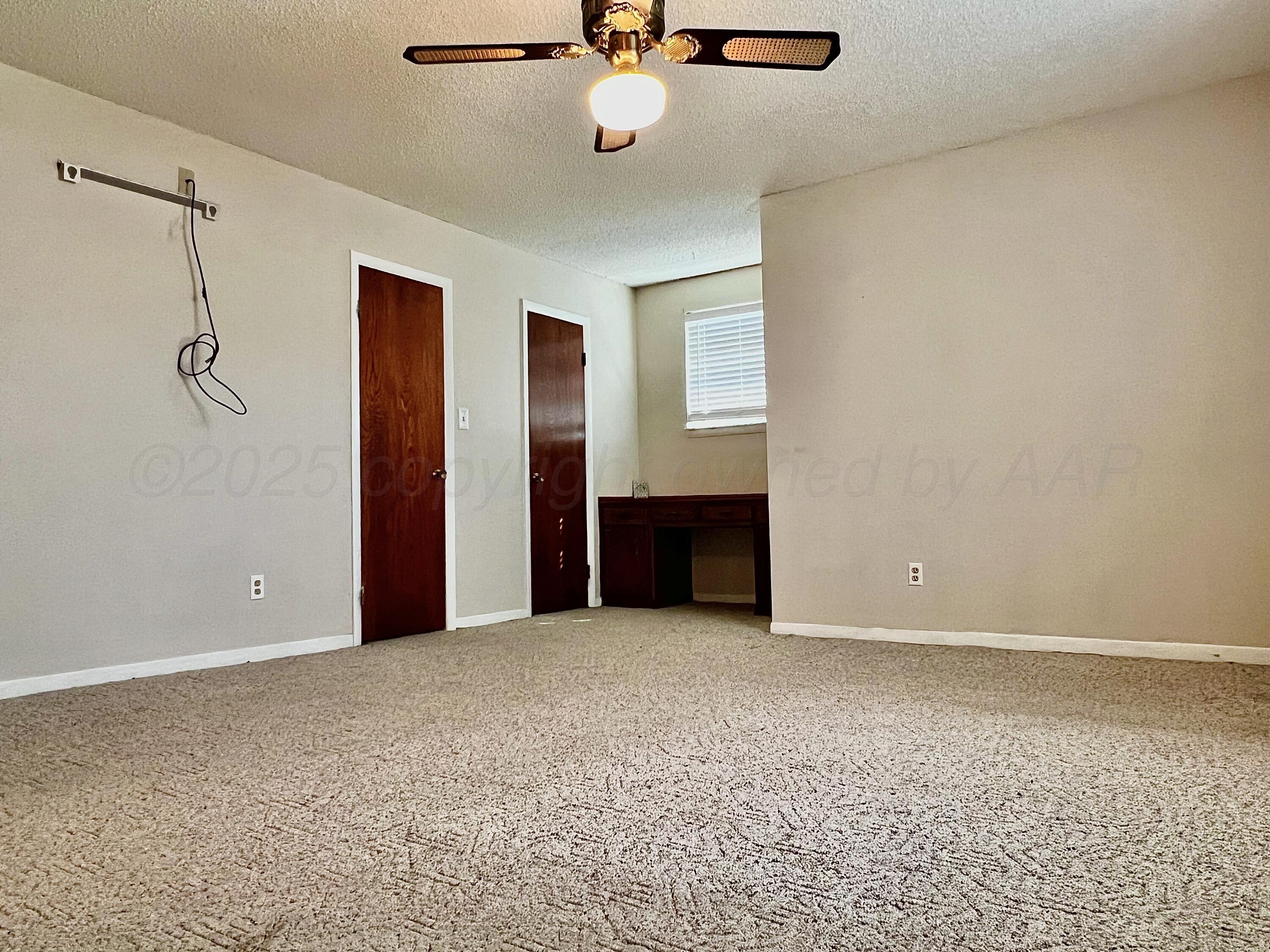 205 Houston Street Borger, TX 79007 - Photo 19 of 25 a view of an empty room with a ceiling fan