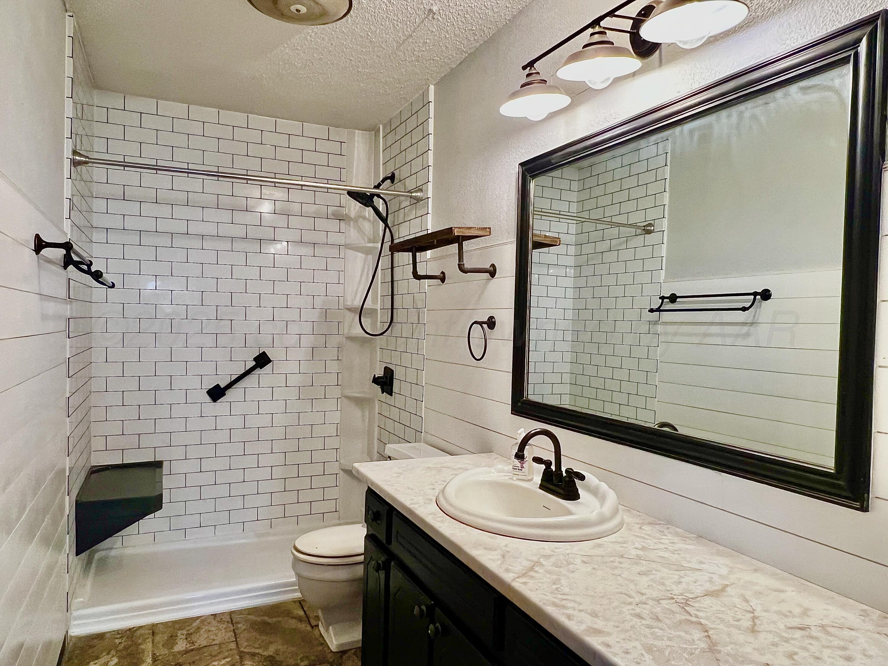 205 Houston Street Borger, TX 79007 - Photo 20 of 25 a bathroom with a sink a toilet and shower