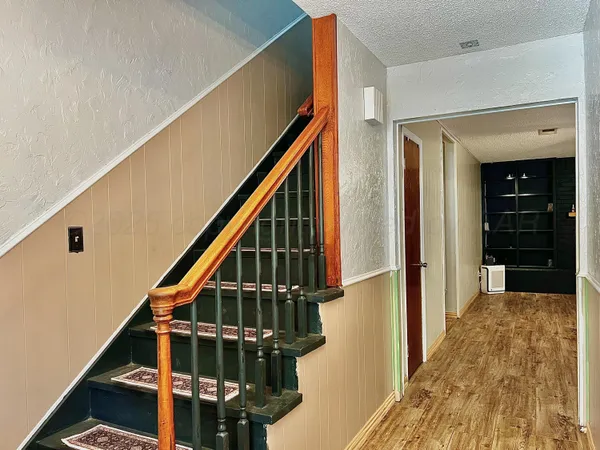 a view of entryway with wooden floor and stairs