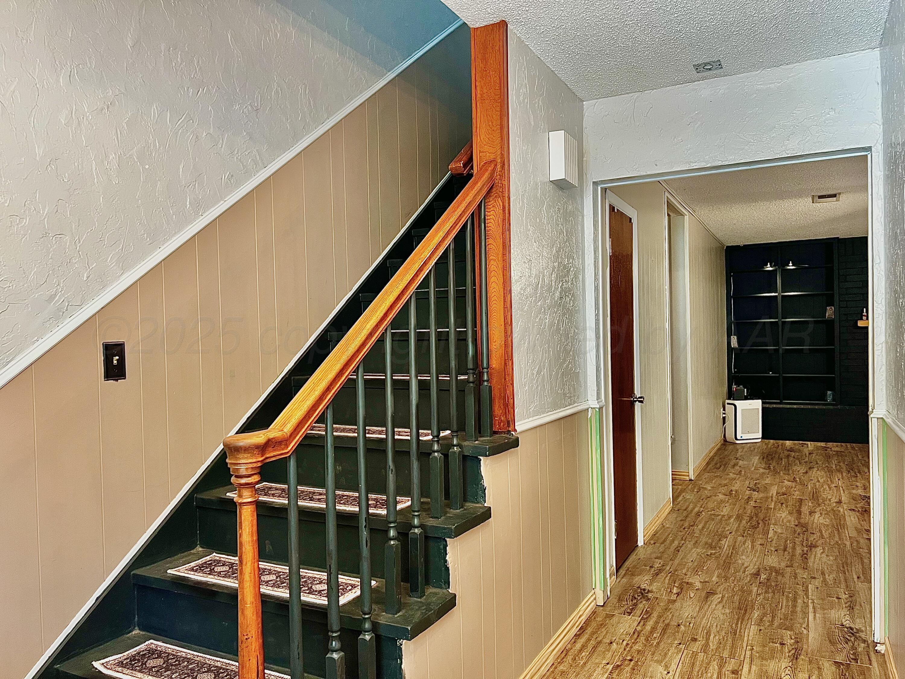 205 Houston Street Borger, TX 79007 - Photo 3 of 25 a view of entryway with wooden floor and stairs