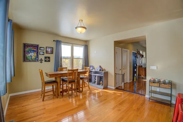a view of a dining room with furniture and wooden floor