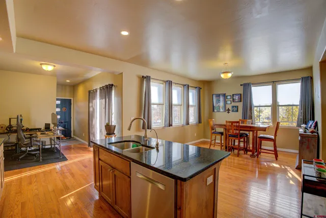 a large kitchen with lots of counter space and windows