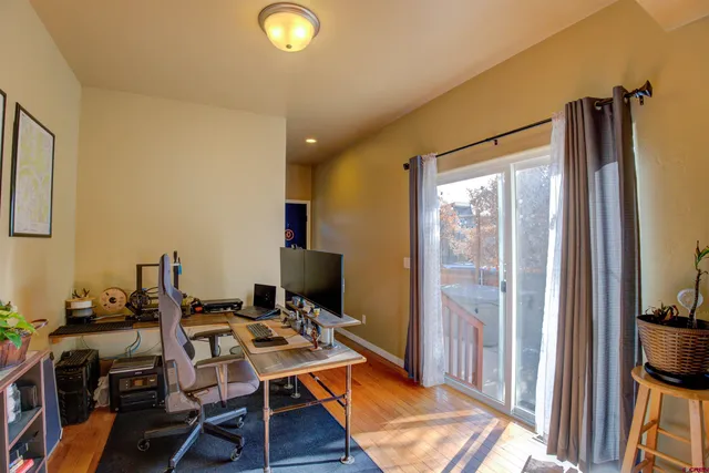 a view of a workspace with furniture and a gate