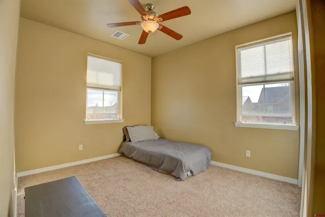 a living room with a bed and a window