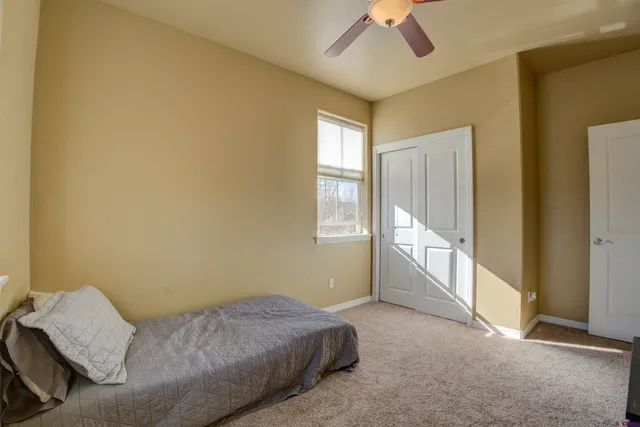 a bed room with a bed and a window